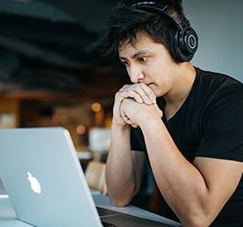 A UB English Language Institute student with headphones